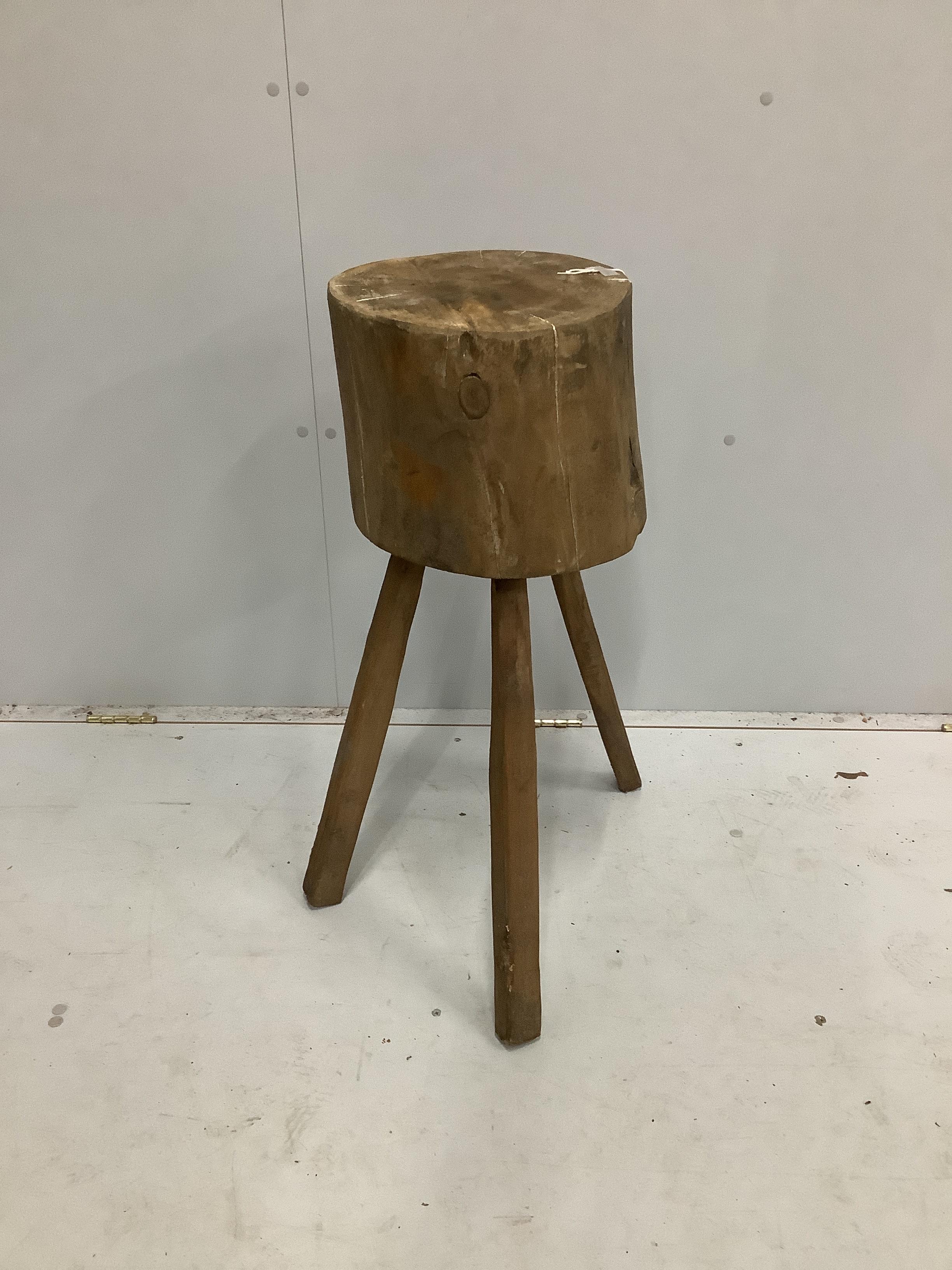 A Provincial trunk section chopping block on tripod stand, height 76cm
